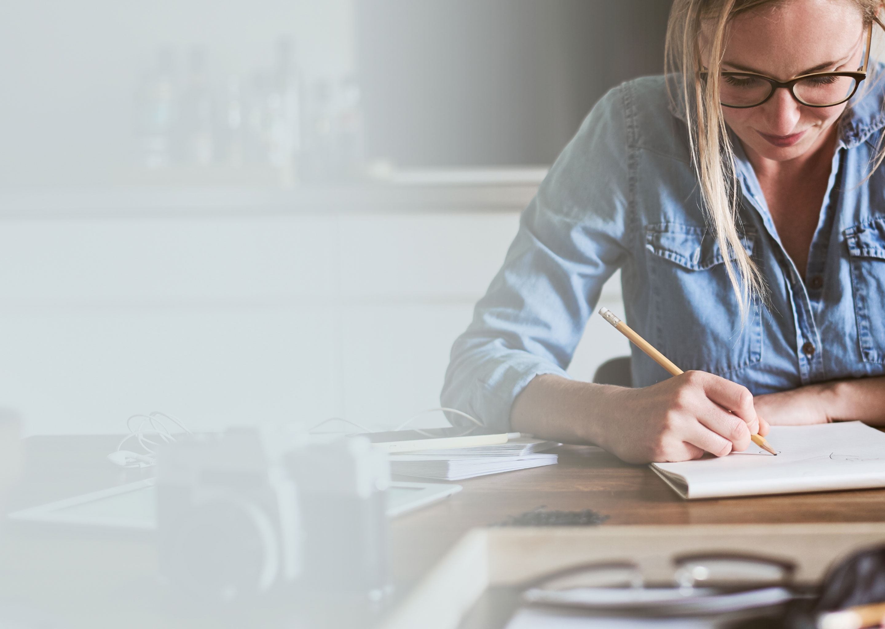 woman at home writing in her notebook